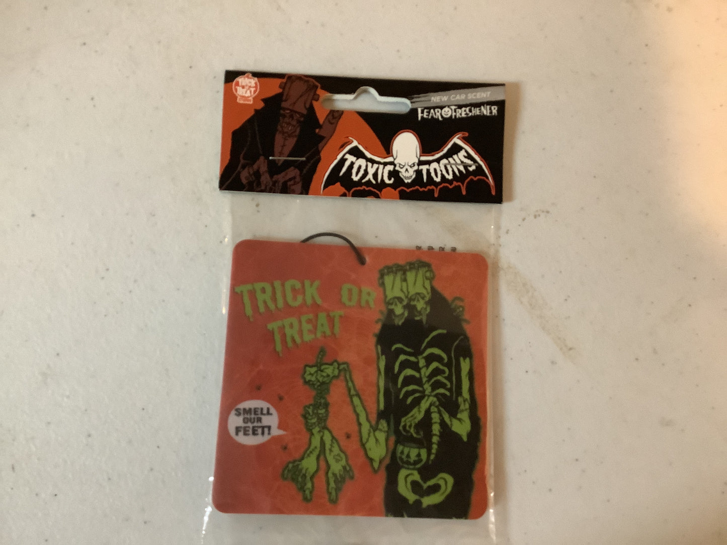 *Fear Freshener Toxictoons Smell Our Feet - New Car